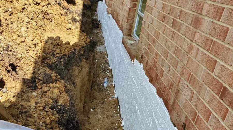waterproofing materials on exterior of home near basement