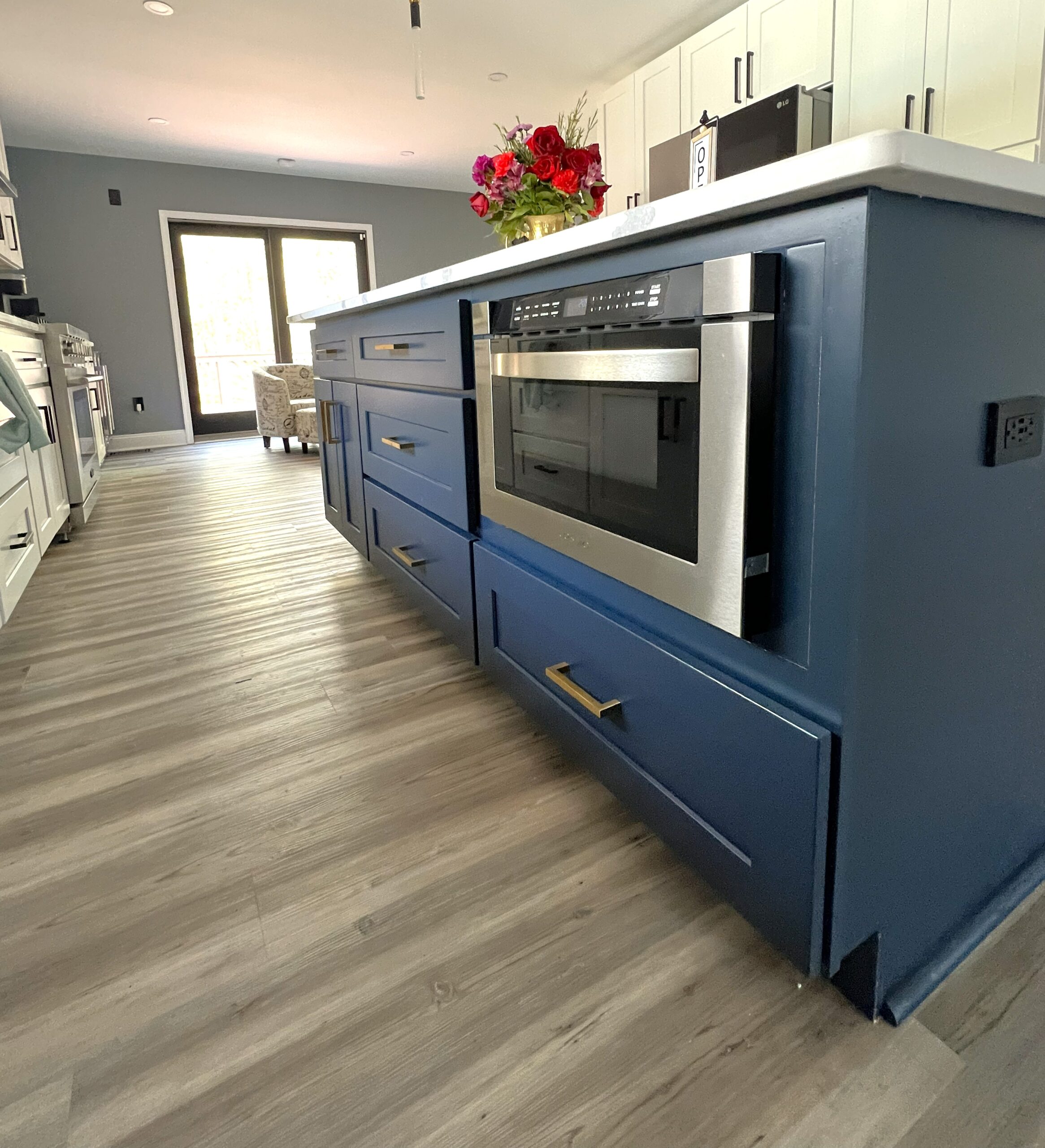 Kitchen island base microwave drawer in naval blue cabinetry in Fort Washington Maryland by MSH Signature