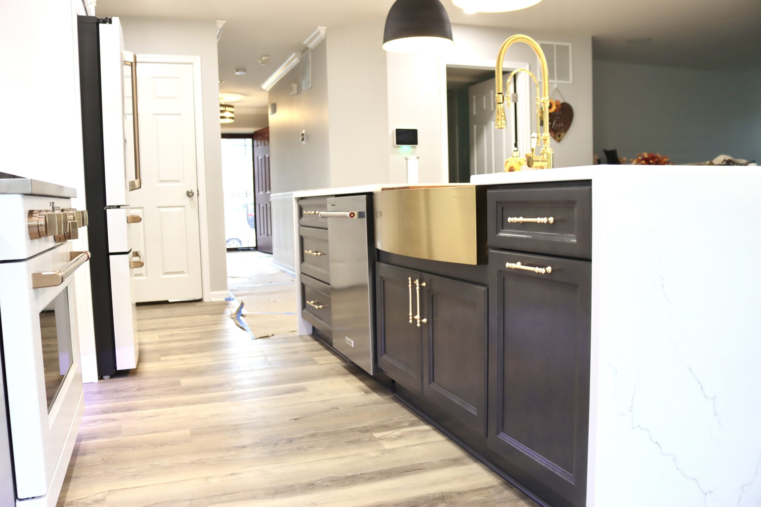 Kitchen island with Calacatta Miraggio waterfall countertop and farmhouse sink in Accokeek Maryland by MSH Signature