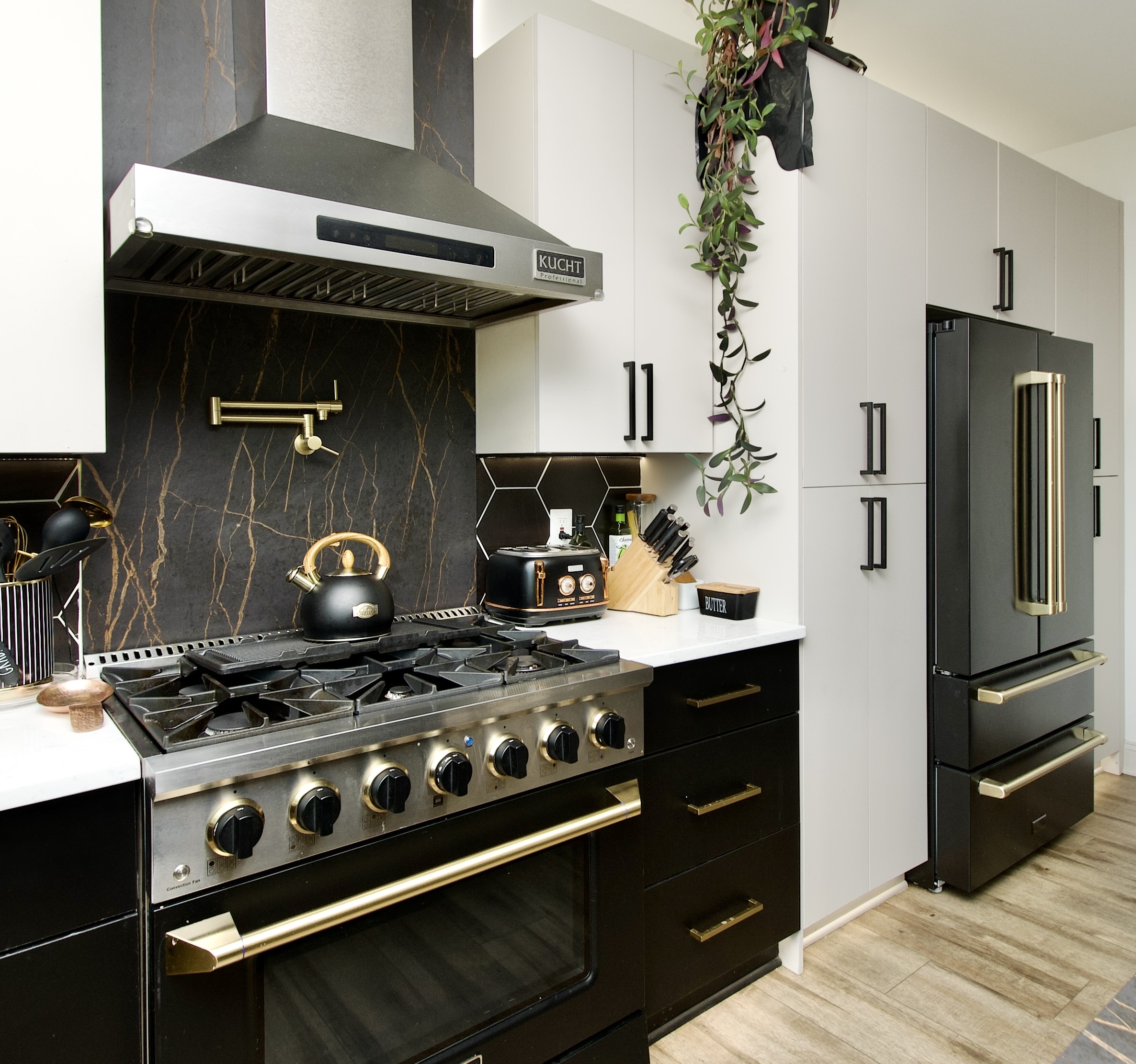Gold pot filler and Dekton Laurent-style statement backsplash in Upper Marlboro, MD