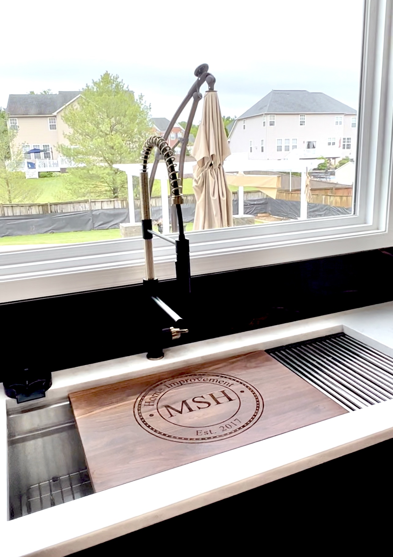 Two-tier workstation sink with modern faucet and Dekton Laurent-style backsplash in Upper Marlboro, MD