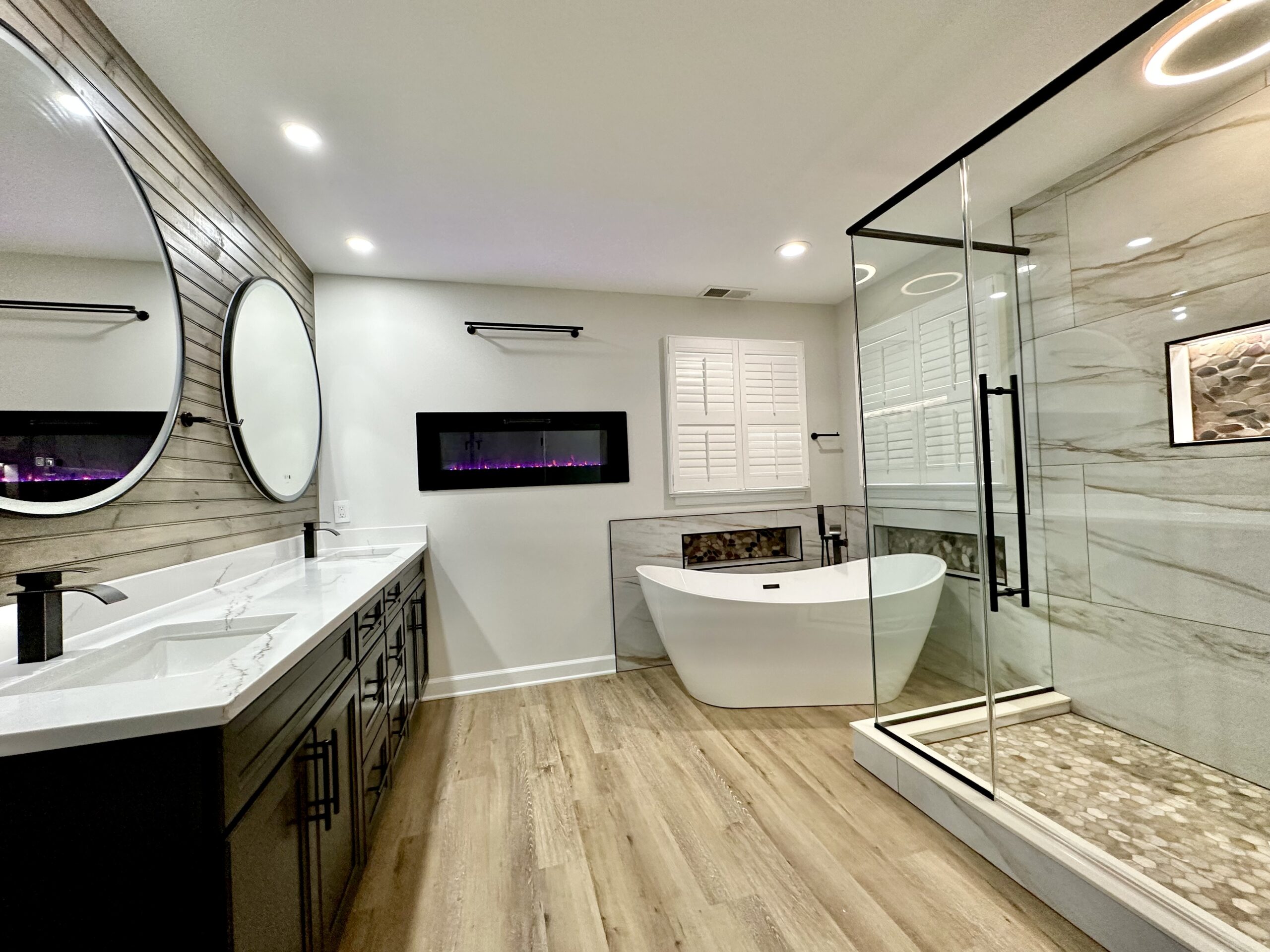 Electric fireplace in primary bathroom Fort Washington MD luxury remodel