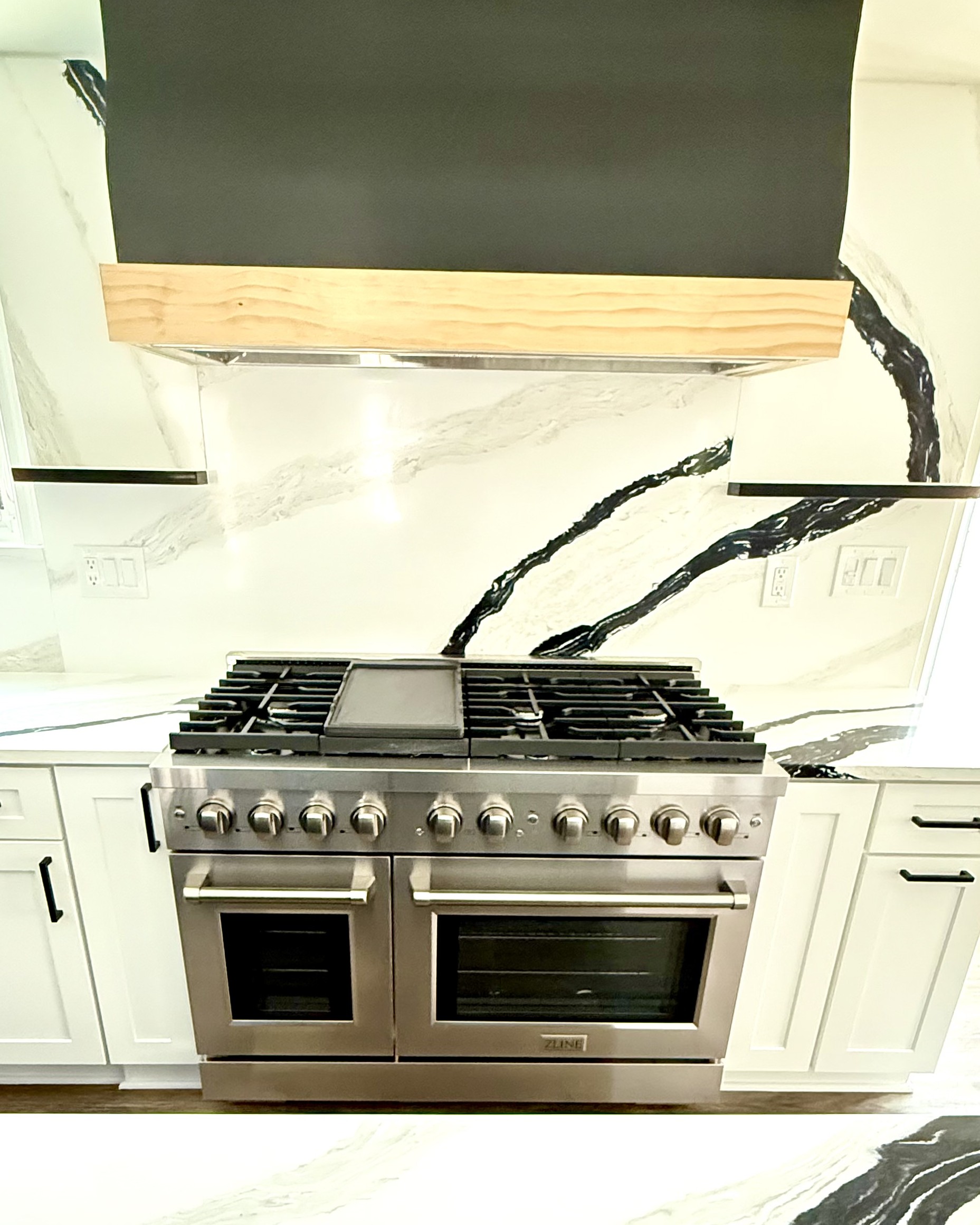 Custom natural wood range hood over gas range in Fort Washington, MD