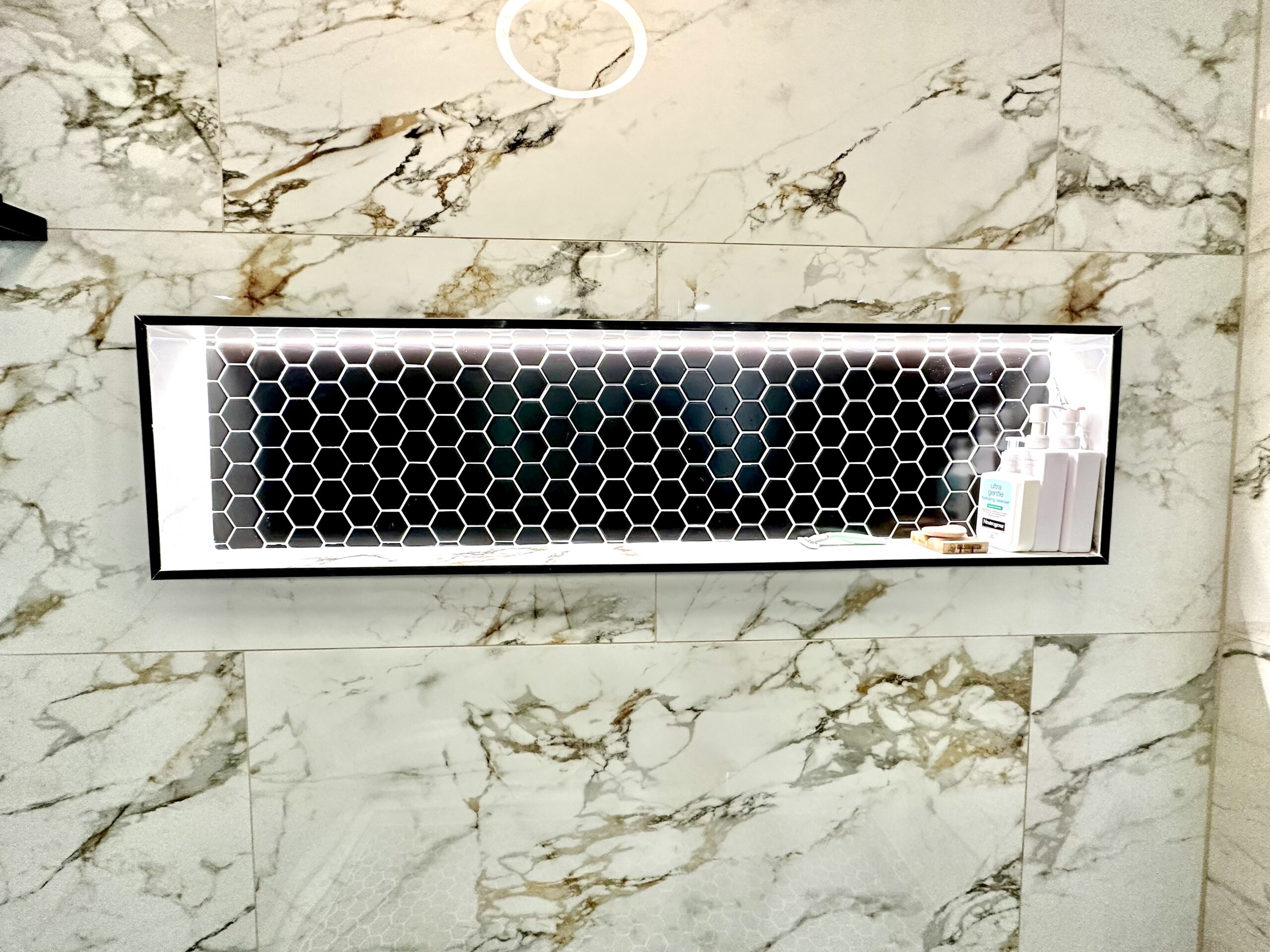 LED shower niche installation in Accokeek Maryland marble bathroom.