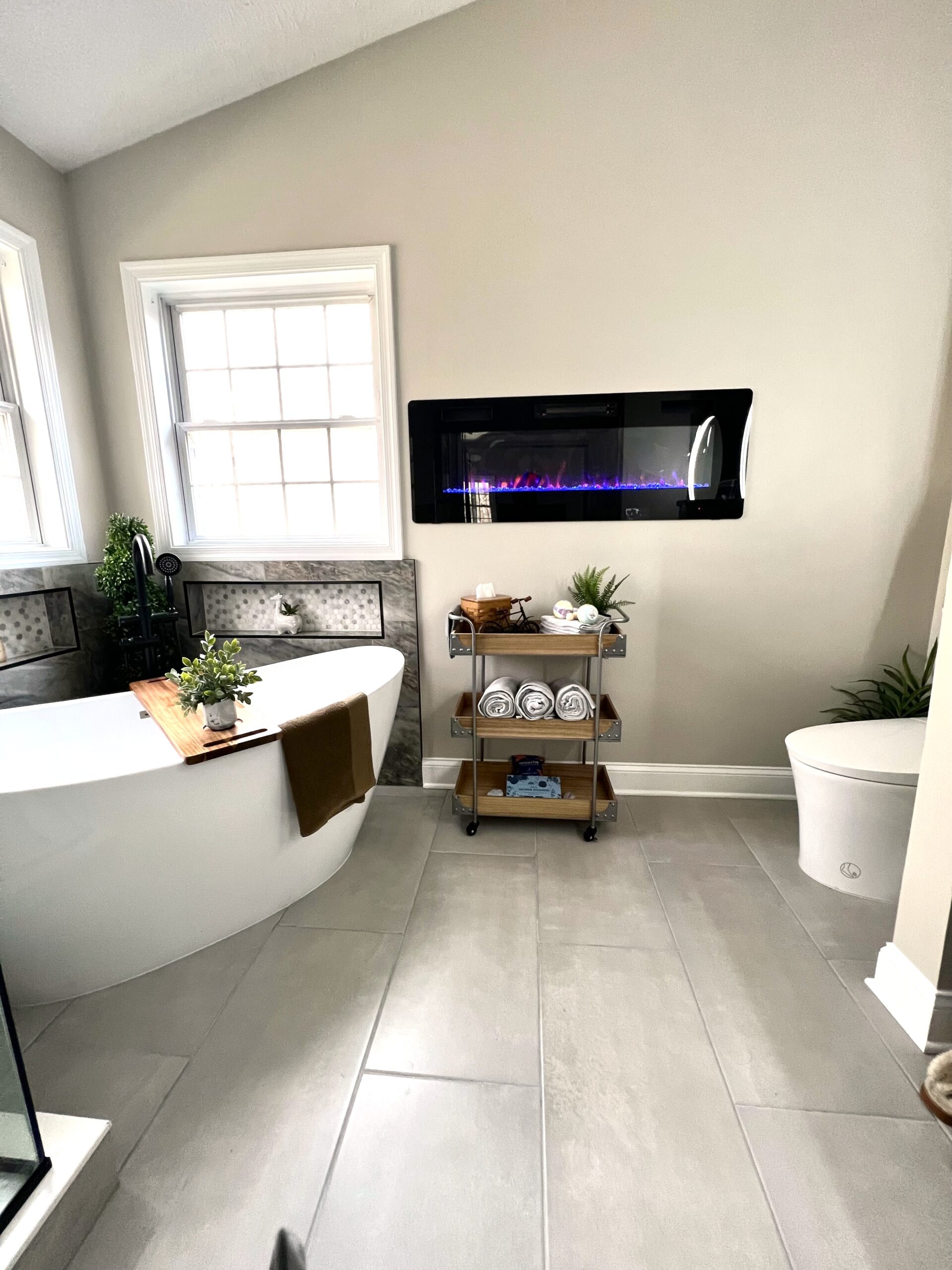 Linear fireplace above bathtub in Fort Washington MD luxury bathroom