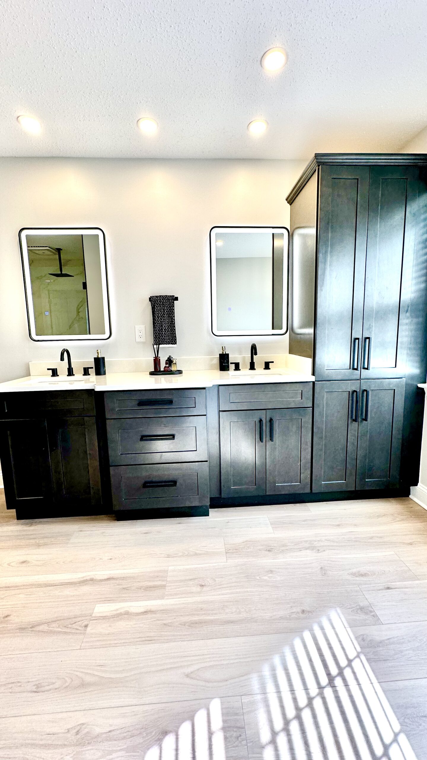 Master bathroom remodel in Brandywine Maryland with double vanity, black fixtures and wood-look floors by MSH Signature Home Improvements.