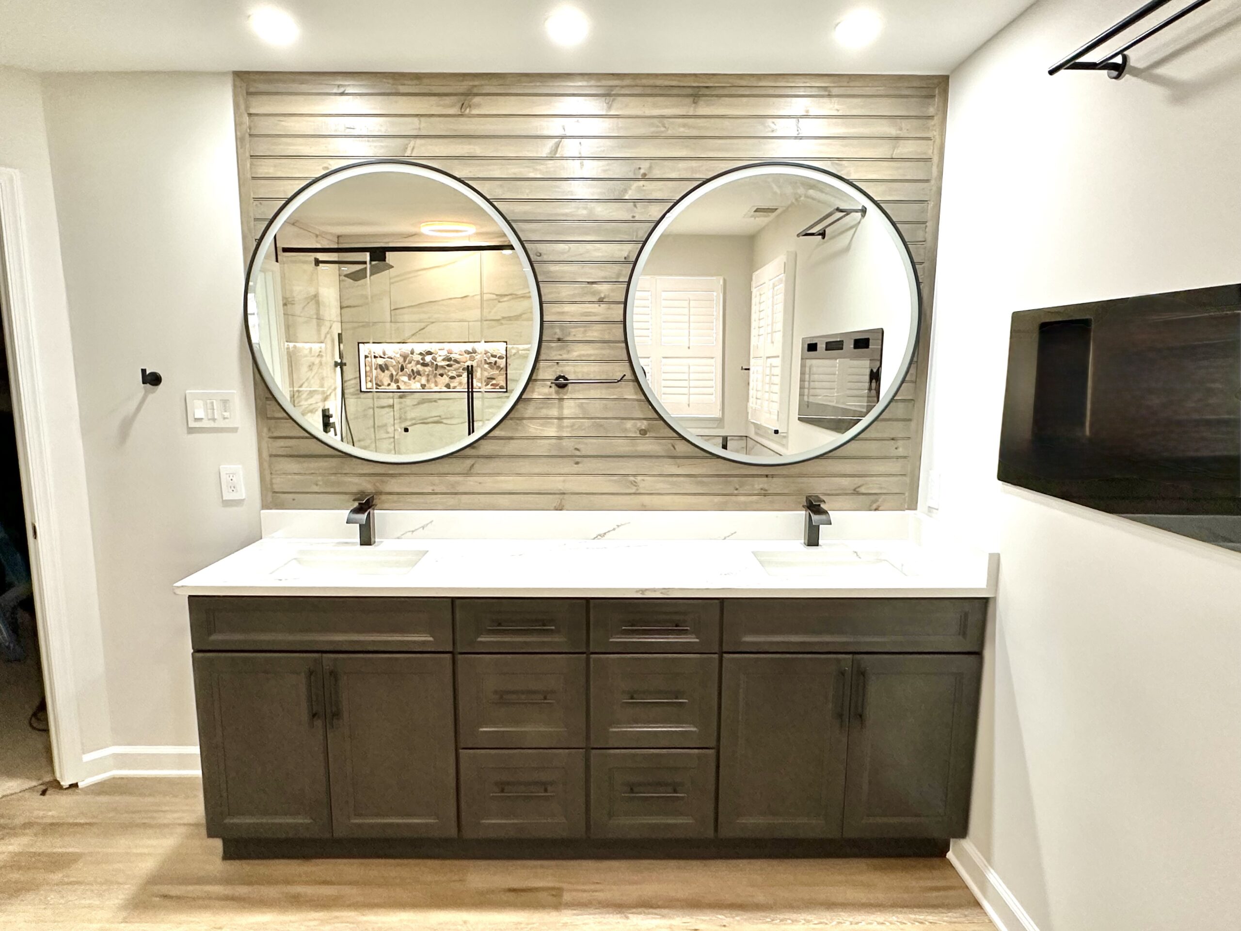 Primary bathroom fireplace with double vanity in Fort Washington MD