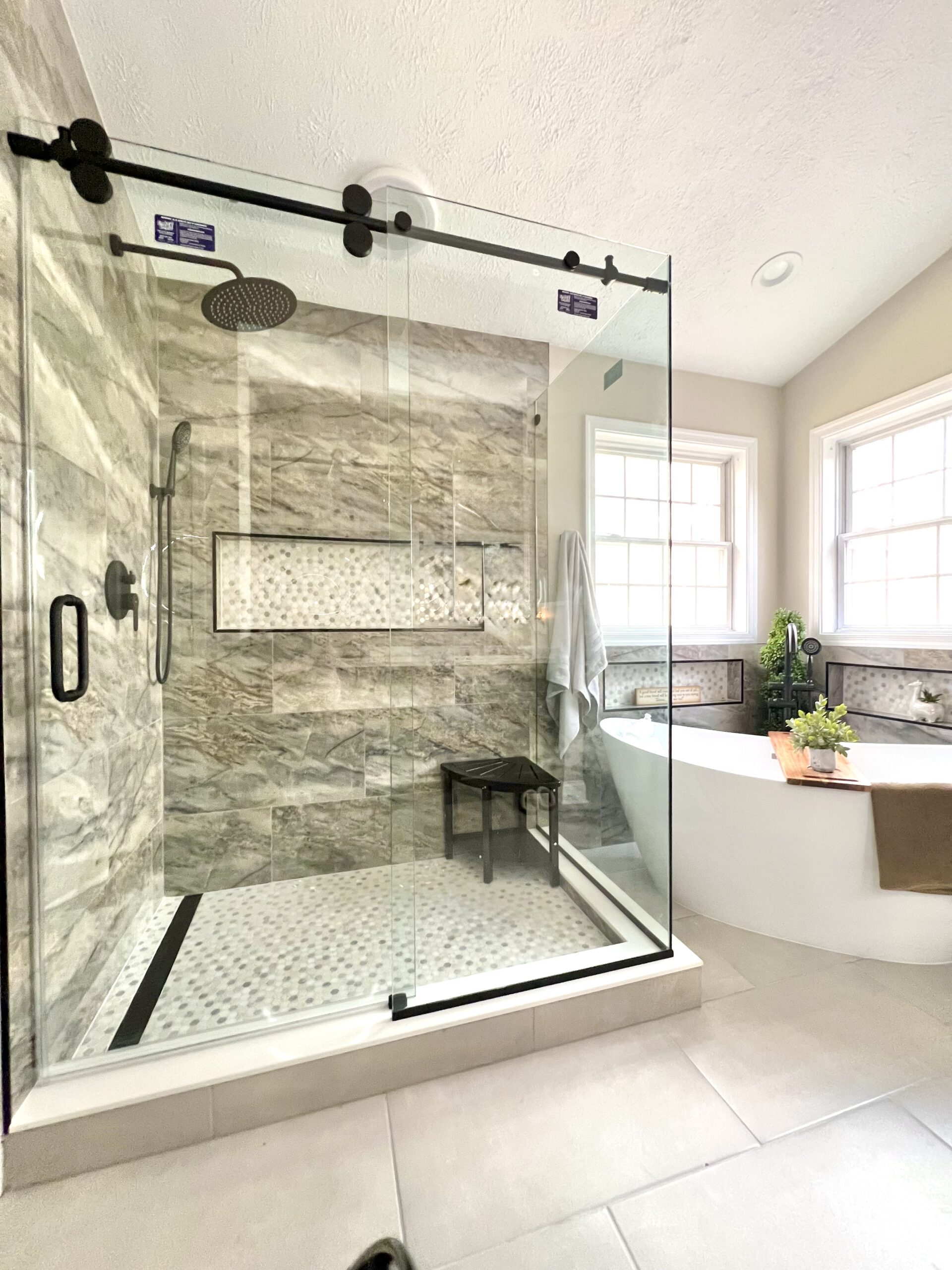 Sliding glass shower enclosure with matte black hardware in Upper Marlboro Maryland